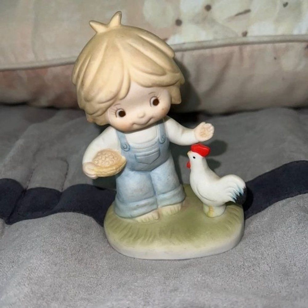 Little boy and rooster figurine